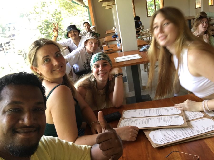 A driver-guide and a table of guests with menus open at a lunch stop on the road between destinations